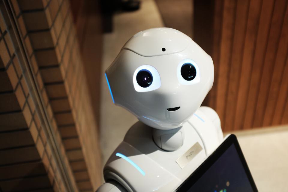 A humanoid robot interacting with a tablet