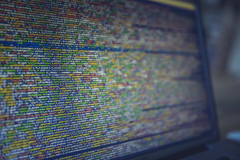 Developer writing code on a screen