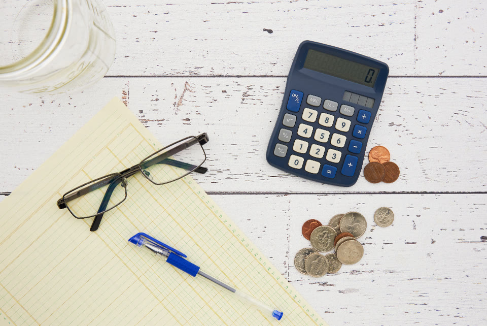 Coins and a calculator representing financial return on investment
